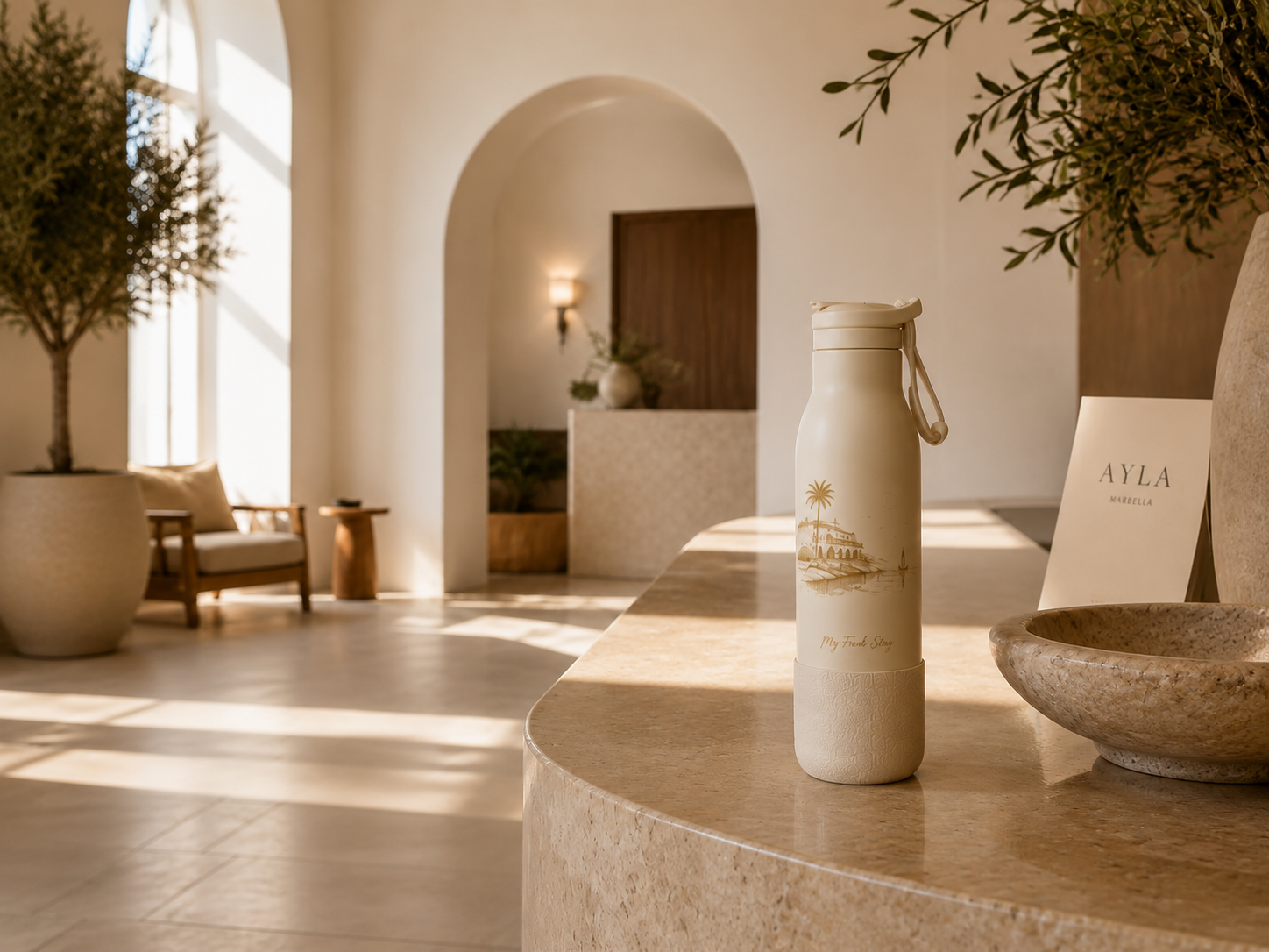 Premium reusable My FreshStay bottle on a travertine hotel reception desk